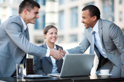 Young business people making a business deal.